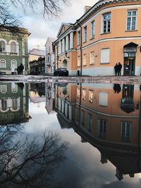 Reflection of buildings in canal in city