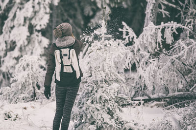 Full length of child on snow covered trees