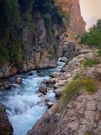 View of river flowing through rocks