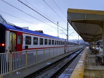 Train at railroad station against sky