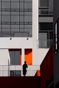 Woman standing against building