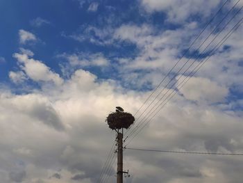 Low angle view of electricity pylon against sky