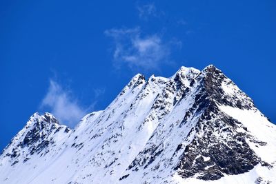 Scenic view of snowcapped mountain against blue sky