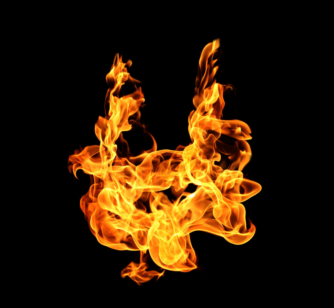 CLOSE-UP OF YELLOW FIRE AGAINST BLACK BACKGROUND