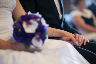 Close-up of hand holding bouquet of people