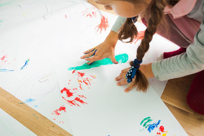 High angle view of mother and daughter on table