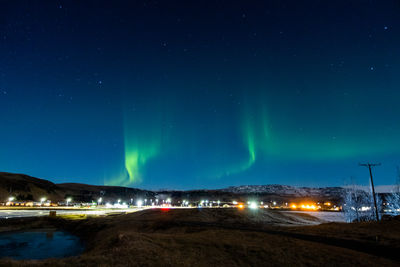 Low angle view of illuminated road at night