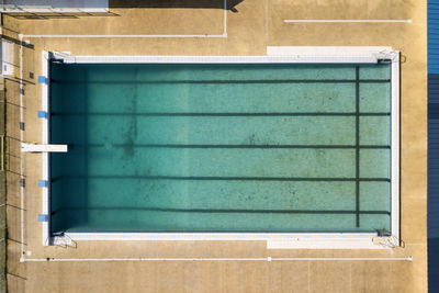 Aerial view of a dirty swimming pool few weeks before the opening season.