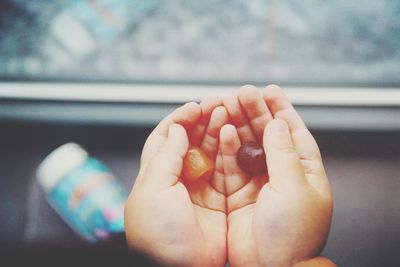 Cropped hands holding candies