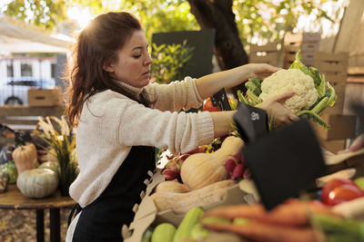 Side view of woman holding food