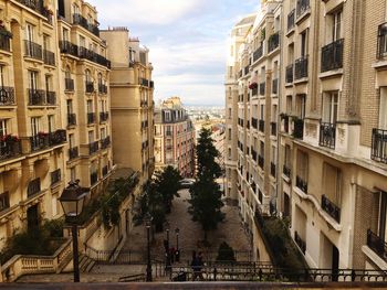 Street amidst buildings in town against sky