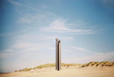 Scenic view of sandy beach against sky