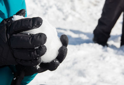 Hands holding snowball