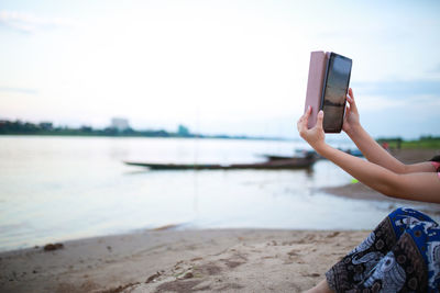 Cropped hands of woman using mobile phone