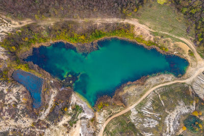 Aerial view of lake amidst dramatic land