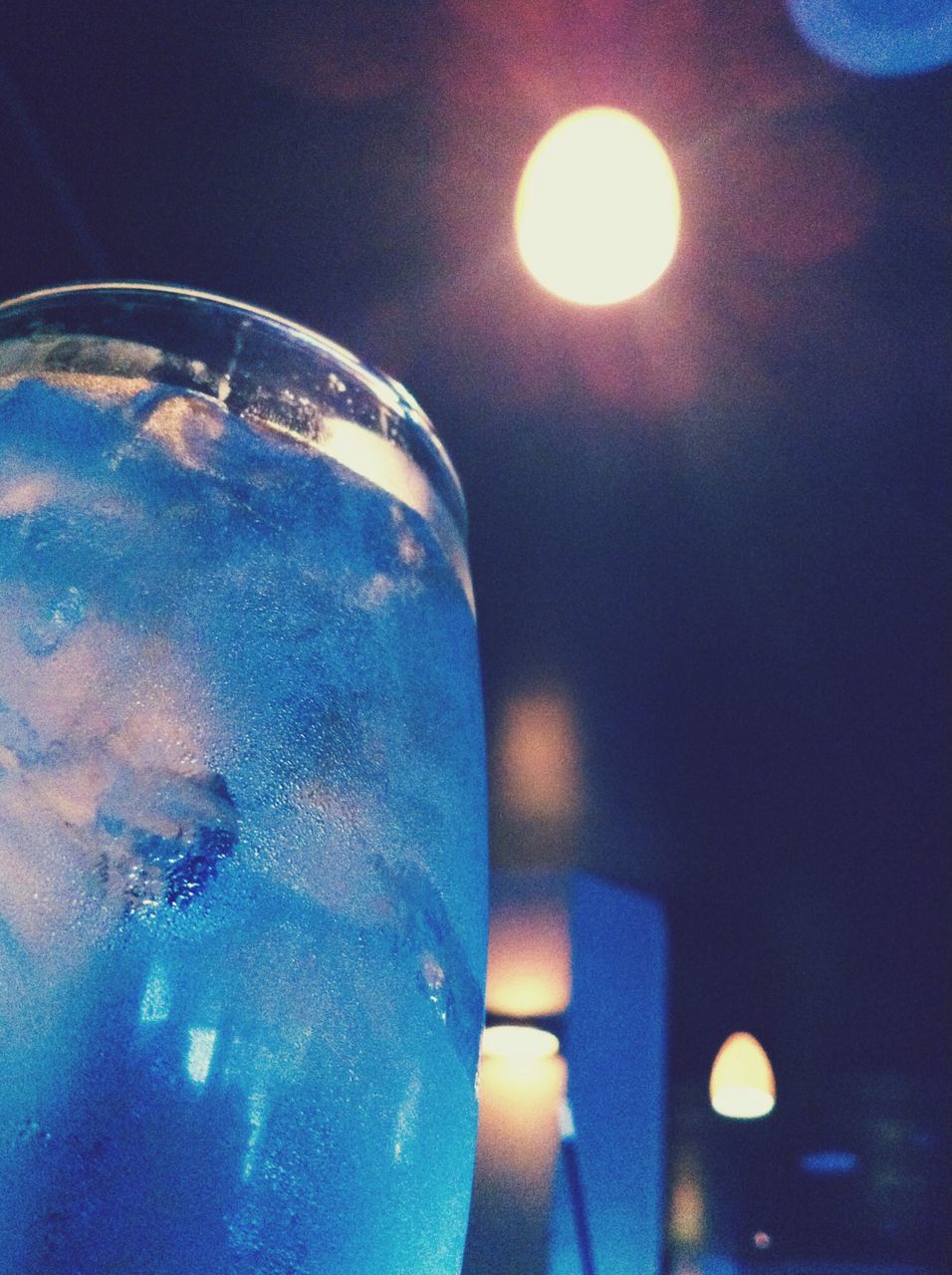 indoors, illuminated, close-up, glowing, glass - material, drink, water, reflection, transparent, refreshment, one person, circle, food and drink, drinking glass, burning, part of, heat - temperature, lighting equipment, flame, light - natural phenomenon