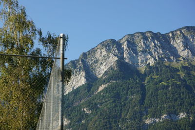 Low angle view of mountain against clear blue sky