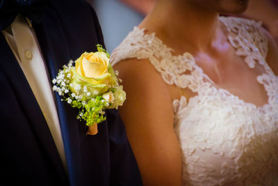 Midsection of woman holding flower bouquet