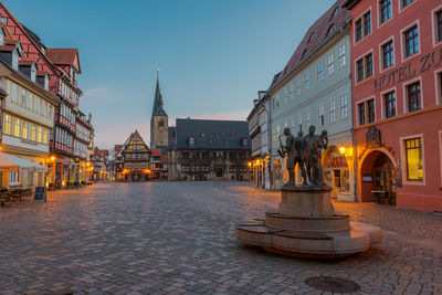 Statue of building in city at dusk