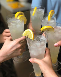 Cropped image of hand holding cocktails 