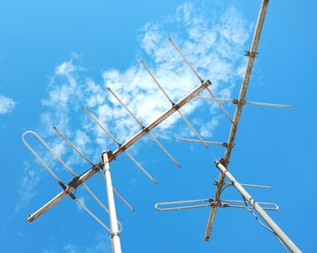 Low angle view of telephone pole against blue sky