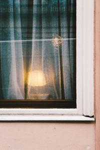 Illuminated lamp seen through window