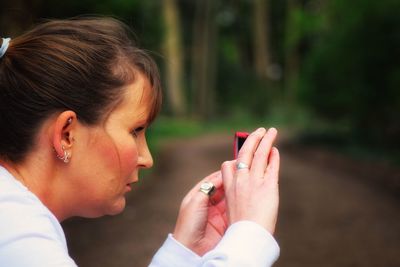 Close-up of woman photographing with mobile phone