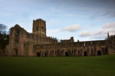 Historic building against cloudy sky