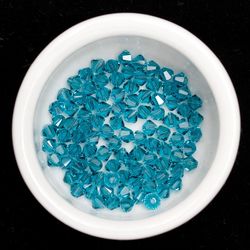 High angle view of blue candies in bowl against black background