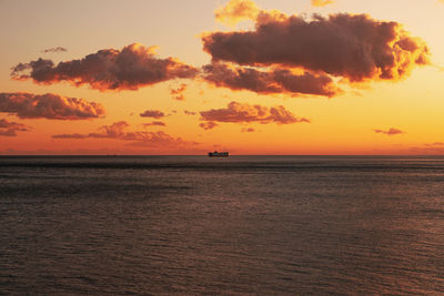 Scenic view of sea against orange sky