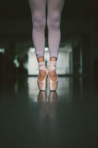 Low section of ballet dancer standing on floor