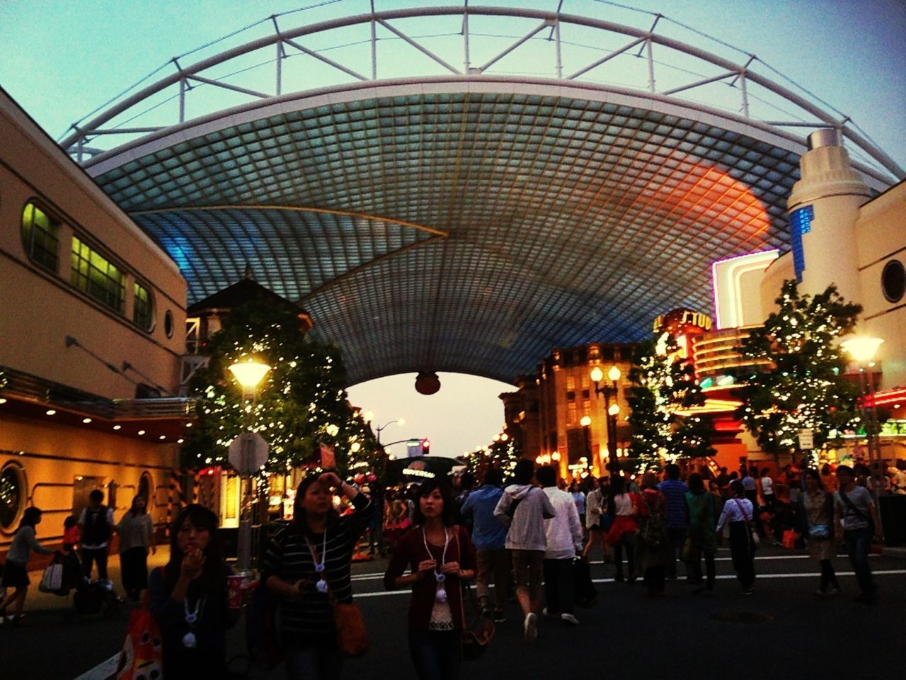 large group of people, illuminated, architecture, built structure, person, men, lifestyles, building exterior, leisure activity, night, lighting equipment, city life, city, crowd, arts culture and entertainment, mixed age range, dusk, sky, walking