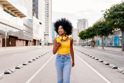 Rear view of woman standing on road