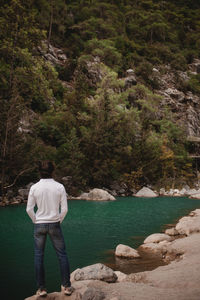 Rear view of man standing in lake