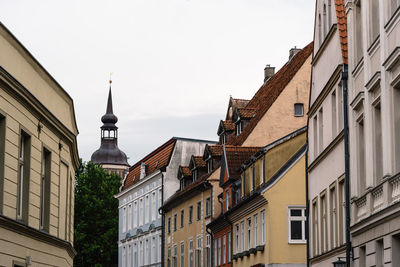 Traditional colorful houses and church tower in the old town of stralsund.