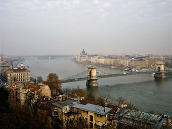 High angle view of bridge over river by buildings in city