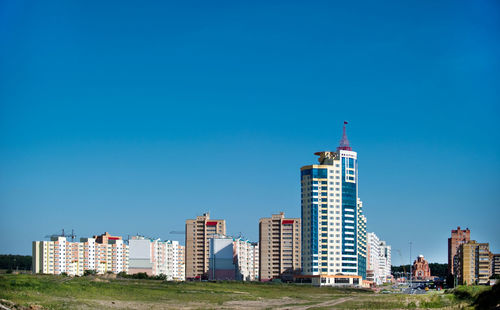 Modern buildings against clear blue sky