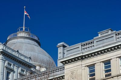 Low angle view of buildings against blue sky