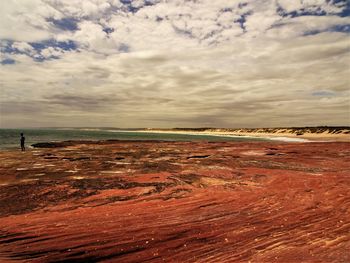 View of beach against cloudy sky