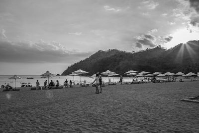 People on beach against sky