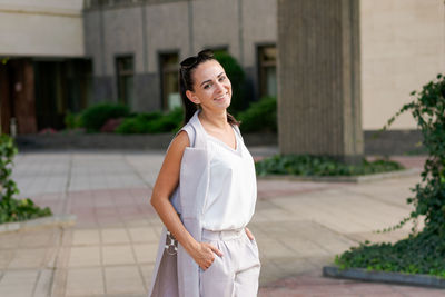 Confident smiling businesswoman standing on the street, portrait. proud