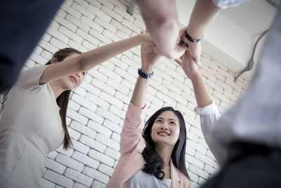 Low angle view of colleagues standing in unity