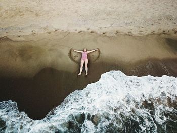 Woman lying at sea shore