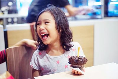 Close-up of happy girl eating