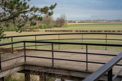 Fence on field against sky