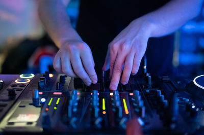 Midsection of man using sound mixer