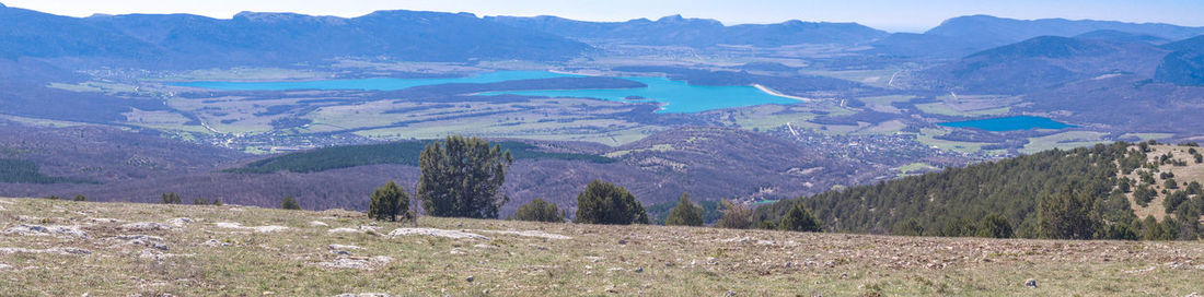 Scenic view of field and mountains against sky