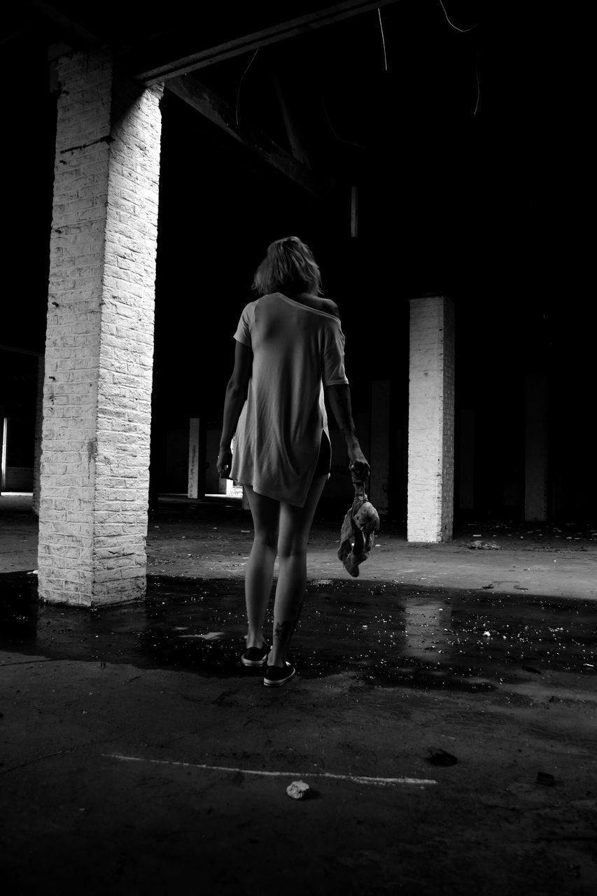 darkness, black, one person, white, full length, architecture, light, rear view, adult, black and white, monochrome, night, built structure, women, monochrome photography, lifestyles, loneliness, city, footwear, casual clothing, street, leisure activity, person, dark, outdoors