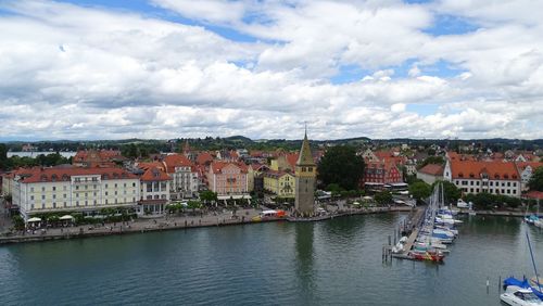 High angle view of river by townscape against sky