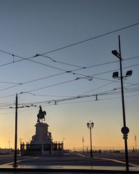 Silhouette of statue at sunset